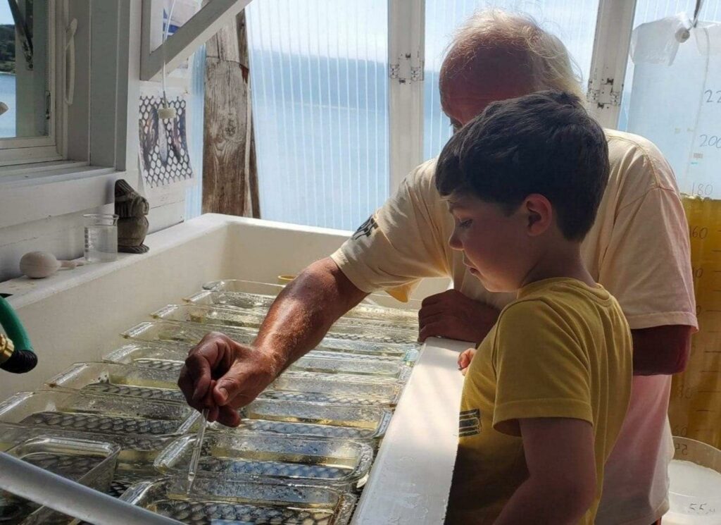 man with child in shellfish lab